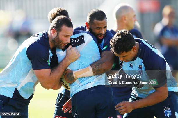 Boyd Cordner of the Blues and Josh Addo-Carr of the Blues tackle a team mate during a New South Wales Blues State of Origin training session at...