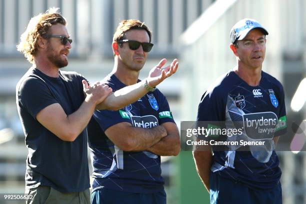 Actor Simon Baker talks to Blues assistant coach Andrew Johns during a New South Wales Blues State of Origin training session at Coogee Oval on July...