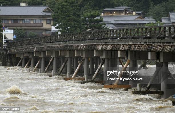 Photo taken on July 6, 2018 shows the Togetsukyo Bridge over the swollen Katsura River in the Arashiyama district of Kyoto, western Japna, following...