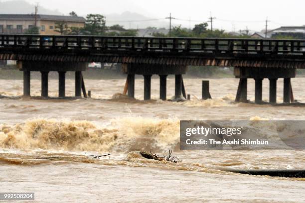 Closed Togetsukyo Bridge is seen as Katsuragawa River is swollen due to heavy rain on July 6, 2018 in Kyoto, Japan. At least one person was killed...