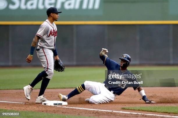 Keon Broxton of the Milwaukee Brewers steals third base past Johan Camargo of the Atlanta Braves in the second inning at Miller Park on July 5, 2018...