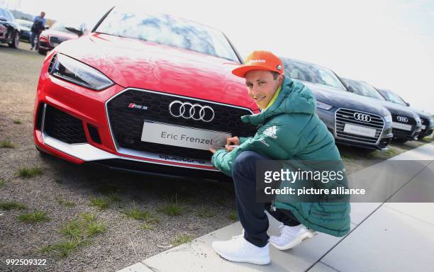 The Nordic combined athlete Eric Frenzel poses next to a sponsored Audi car for a press conference for the outfitting of the German Ski Association...
