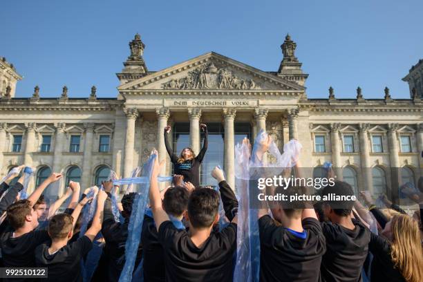 Youths dance during a dance protest of the relief organisation Misereor in front of the Reichstag building in Berlin, Germany, 19 October 2017. The...