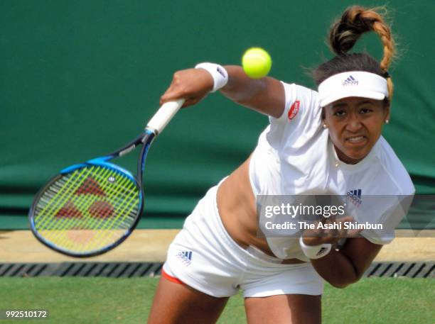 Naomi Osaka of Japan serves during her Ladies' Singles second round match against Katie Boulter of Great Britain on day four of the Wimbledon Lawn...