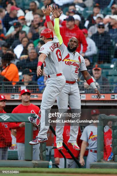 Matt Carpenter of the St Louis Cardinals celebrates with teammate Marcell Ozuna after hitting a solo home run in the second inning against the San...