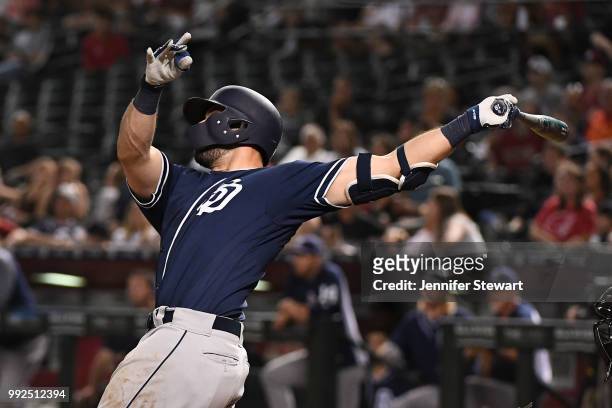 Austin Hedges of the San Diego Padres hits a solo home run in the fifth inning of the MLB game against the Arizona Diamondbacks at Chase Field on...