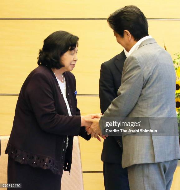 Former abductee by North Korea Hitomi Soga shakes hands with Prime Minister Shinzo Abe prior to their meeting at the prime minister's official...