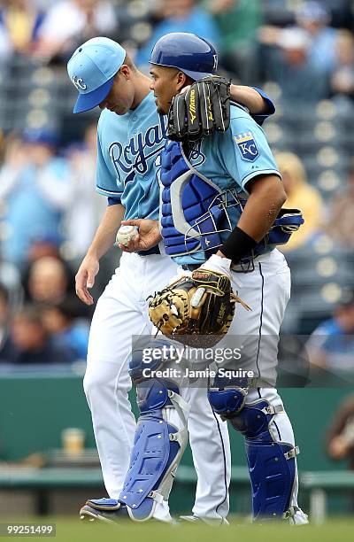 Starting pitcher Zack Greinke of the Kansas City Royals consults with catcher Brayan Pena after a play at the plate during the 1st inning of the game...