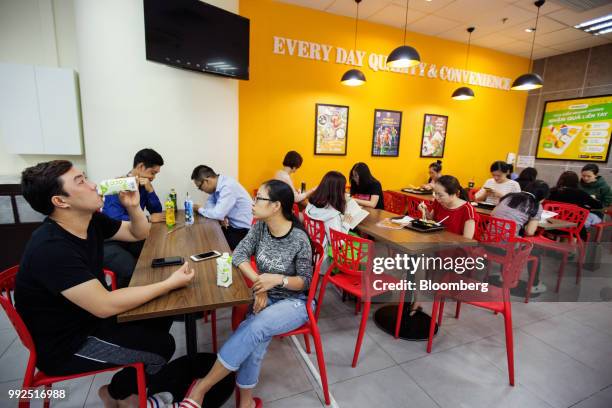 Customers dine and drink at tables in a 7-Eleven store in Ho Chi Minh City, Vietnam, on Wednesday, June 20, 2018. For decades, Vietnamese have...