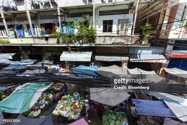 Tethered cables pass over a market covered by parasols in Ho Chi Minh City, Vietnam, on Wednesday, June 20, 2018. For decades, Vietnamese have...