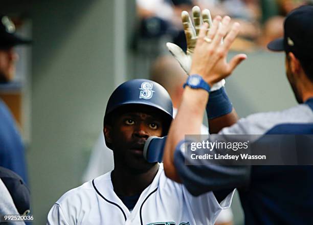 Guillermo Heredia of the Seattle Mariners is greeted in the dugout after scoring in the third inning on a single by Dee Gordon against the Los...