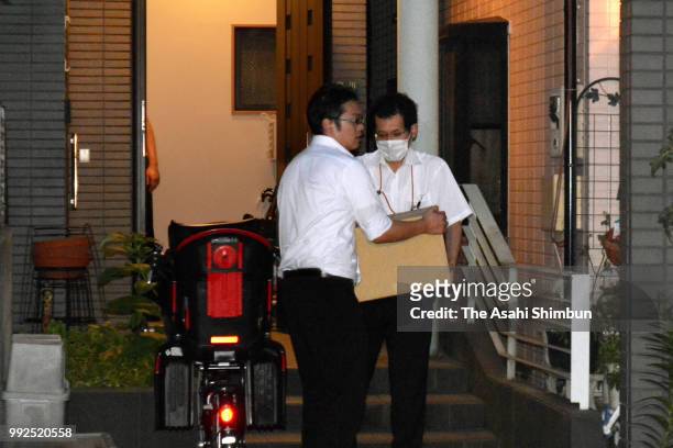 Tokyo District Public Prosecutors Office Special Investigation Team members load boxes containing seized documents after the arrest of Education...