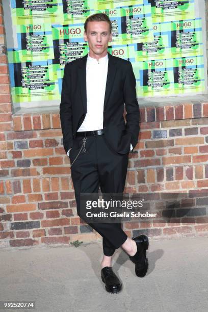 Jamie Campbell Bower attends the HUGO show during the Berlin Fashion Week Spring/Summer 2019 at Motorwerk on July 5, 2018 in Berlin, Germany.