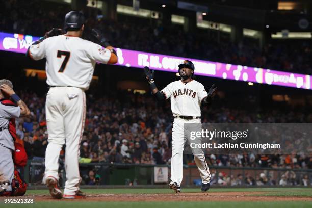 Alen Hanson of the San Francisco Giants celebrates with Gorkys Hernandez after hitting a two-run home run in the sixth inning against the St Louis...