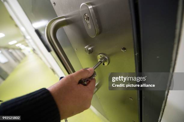 Judicial officer unlocks the door to a cell in a new prison building during a tour after the official opening at the Justizvollzugsanstalt Stammheim...
