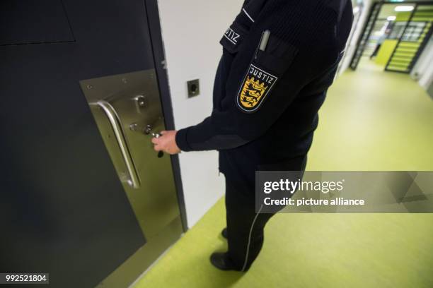 Judicial officer unlocks the door to a holding cell in a new prison building during a tour after the official opening at the Justizvollzugsanstalt...