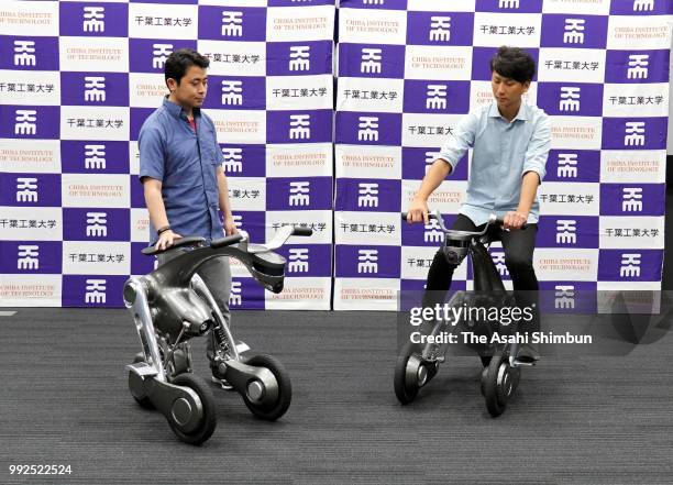 Two riders showing off the capabilities of two CanguRo rideable robots developed by a tem at Future Robotics Technology Center, Chiba Institute of...