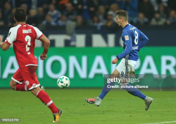 Leon Goretzka of Schalke scores to make it 1:0 beside Giulio Donati of Mainz during the German Bundesliga football match between FC Schalke 04 and...