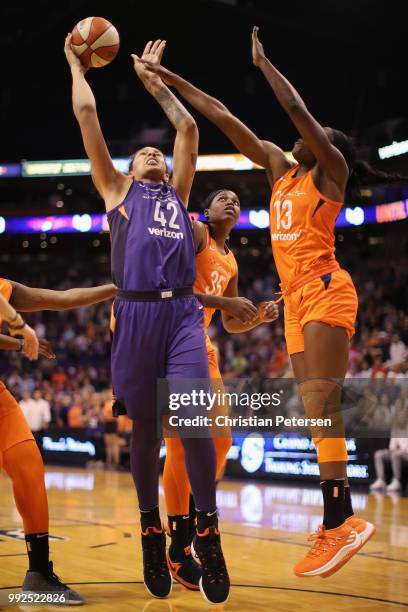 Brittney Griner of the Phoenix Mercury attempts a shot over Chiney Ogwumike of the Connecticut Sun during the first half of WNBA game at Talking...