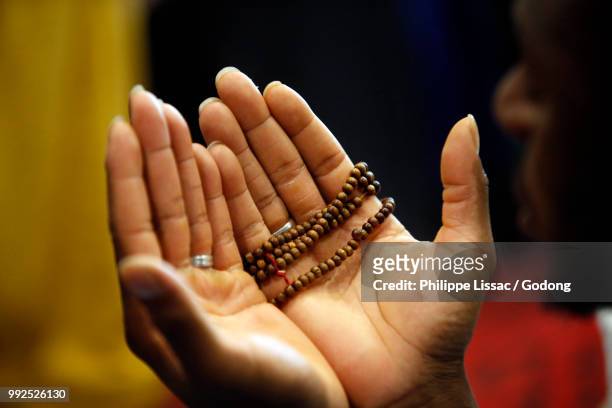muslim woman praying in saint-ouen, france. - praying stock pictures, royalty-free photos & images