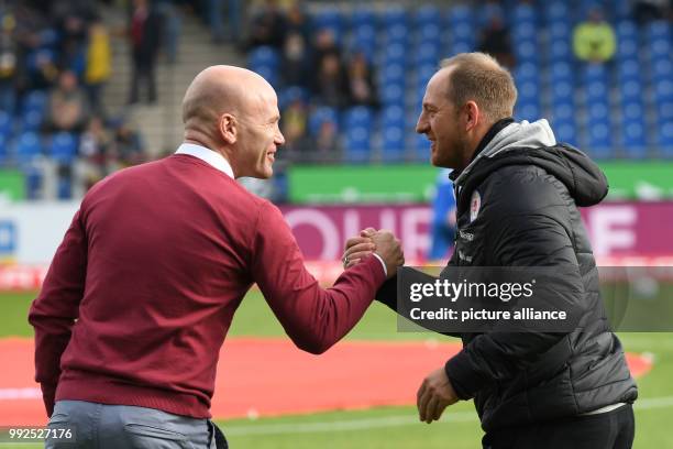 Bochum's coach Jens Rasiejewski and Braunschweig's coach Torsten Lieberknecht shake hands before the 2nd Bundesliga soccer match between Eintracht...