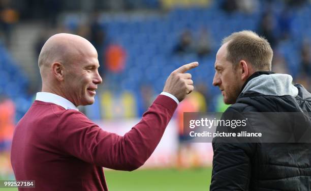 Bochum's coach Jens Rasiejewski and Braunschweig's coach Torsten Lieberknecht greet each other before the 2nd Bundesliga soccer match between...