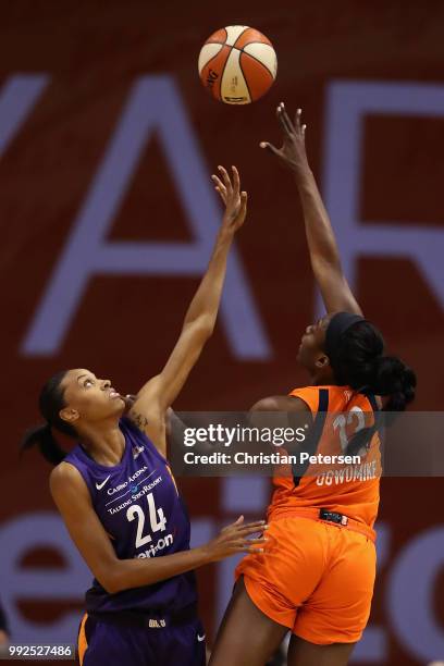 Chiney Ogwumike of the Connecticut Sun attempts a shot over DeWanna Bonner of the Phoenix Mercury during the first half of WNBA game at Talking Stick...