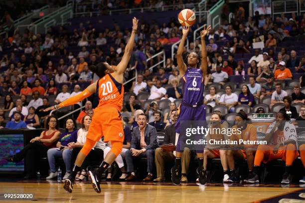 Yvonne Turner of the Phoenix Mercury attempts a shot over Alex Bentley of the Connecticut Sun during the first half of WNBA game at Talking Stick...