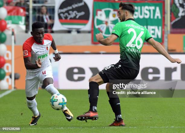 Augsburg's Daniel Opare and Hanover's Kenan Karaman in ction during the German Bundesliga soccer match between FC Augsburg and Hanover 96 at the...