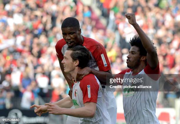 Augsburg's Kevin Danso , goal scorer Michael Gregoritsch and Caiuby celebrate after the 1-0 during the German Bundesliga soccer match between FC...