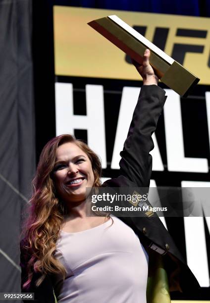 Ronda Rousey poses with her trophy after her induction into the UFC Hall of Fame during the UFC Hall of Fame Class of 2018 Induction Ceremony inside...