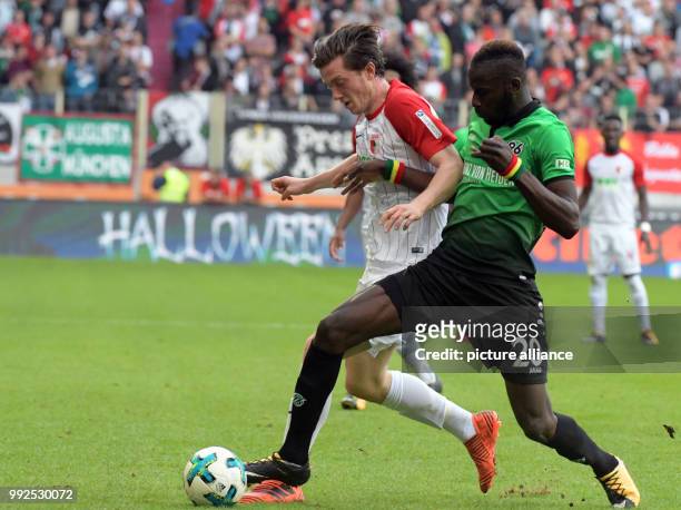 Augsburg's Michael Gregoritsch and Salif Sané of Hanover vie for the ball during the German Bundesliga soccer match between FC Augsburg and Hanover...