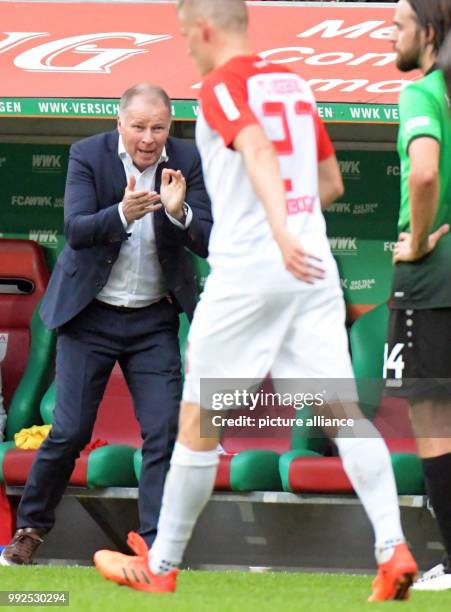 Augsburg's sports director Stefan Reuter gestures during the German Bundesliga soccer match between FC Augsburg and Hanover 96 at the WWK Arena in...