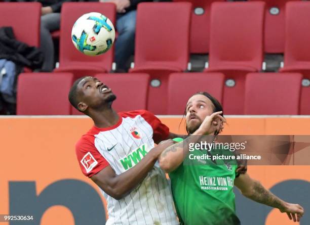 Augsburg's Kevin Danso in action against Hanover's Martin Harnik during the German Bundesliga soccer match between FC Augsburg and Hanover 96 at the...