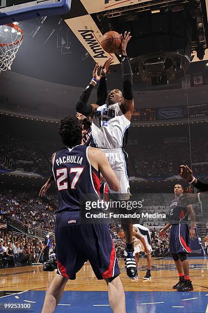 Dwight Howard of the Orlando Magic goes up for a shot against Zaza Pachulia and Josh Smith of the Atlanta Hawks in Game Two of the Eastern Conference...