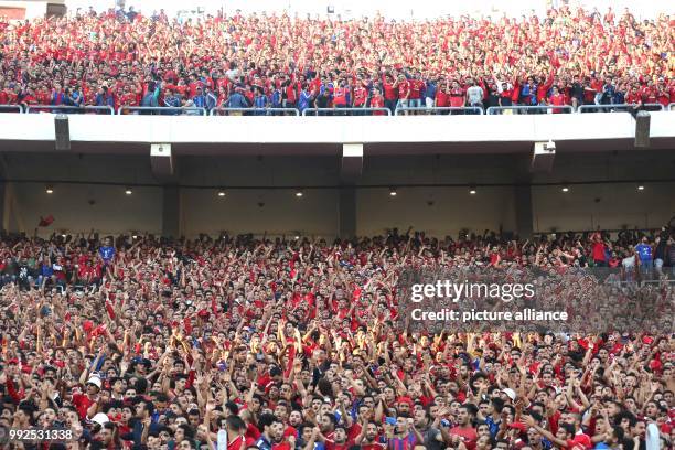 Supporters of Egypt's Al-Ahly cheer for their team during the second-leg of the CAF Champions League Semifinal football match between Tunisia's...