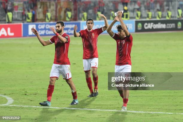 Dpatop - Al Ahly players Amro El-Soulia , Ramy Rabia and Mohamed Hany acknowledge supporters after the final whistle of the second-leg of the CAF...