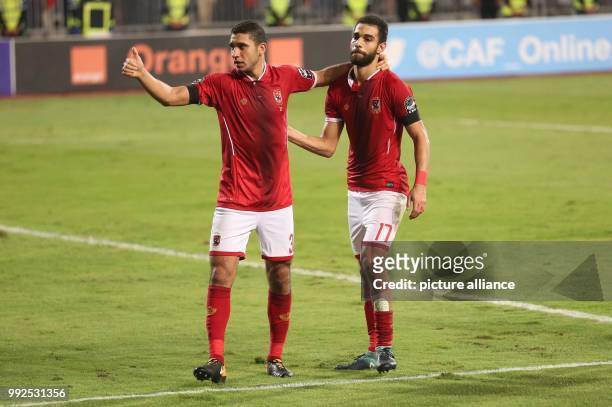 Al Ahly's Ramy Rabia gives a thumbs up as he celebrates scoring his side's sixth goal with teammate Amro El-Soulia during the second-leg of the CAF...