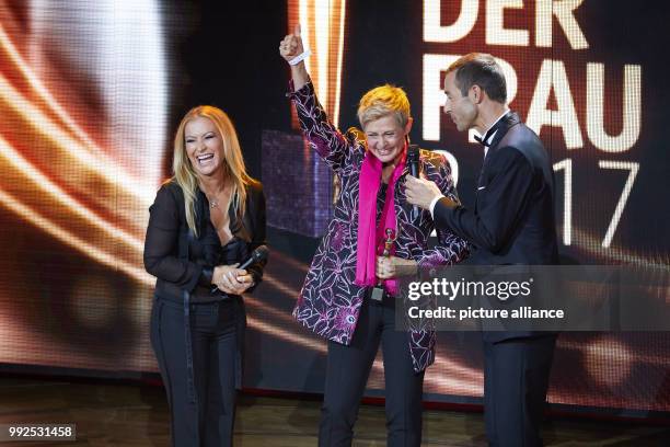 Singer Anastacia , award winner Barbara Staecker and TV presenter Kai Pflaume standing onstage during the the award ceremony of the "Goldene Bild der...