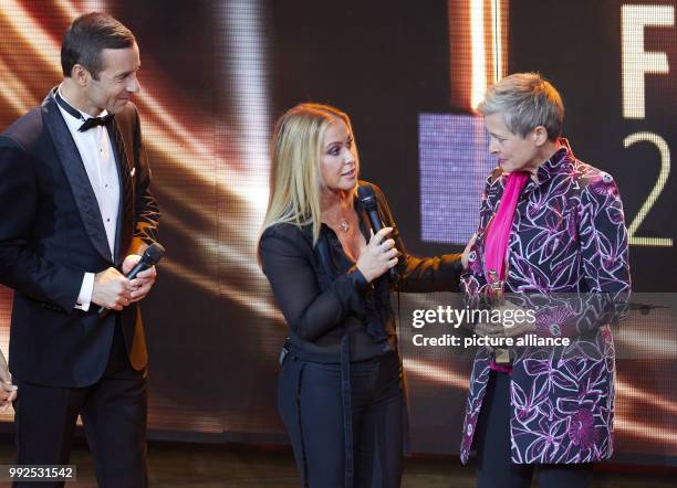 Presenter Kai Pflaume , singer Anastacia and award winner Barbara Staecker standing onstage during the the award ceremony of the "Goldene Bild der...