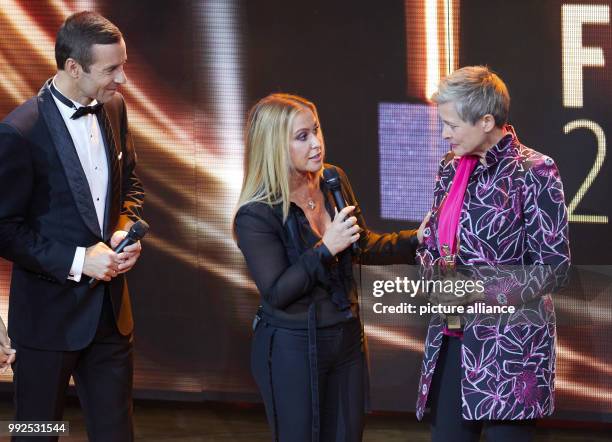 Presenter Kai Pflaume , singer Anastacia and award winner Barbara Staecker standing onstage during the the award ceremony of the "Goldene Bild der...