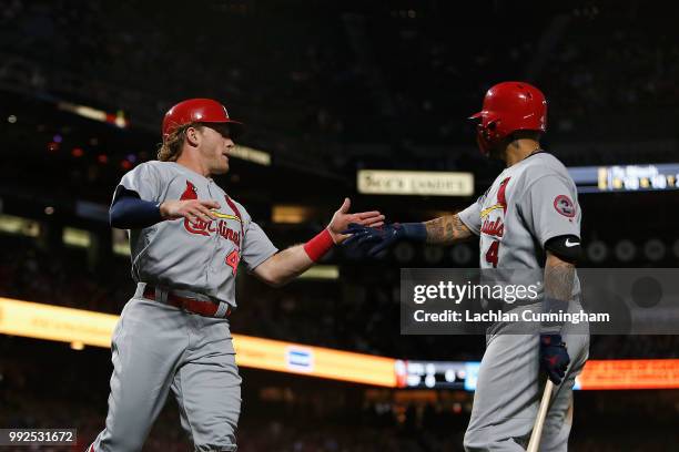 Harrison Bader of the St Louis Cardinals celebrates with teammate Yadier Molina after scoring a run on a single hit by Tommy Pham in the sixth inning...