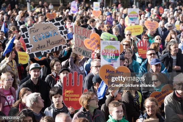 Dpatop - People hold placards with Anti-Racism slogans as they gather to attend a demonstration with the slogan " Against Racism and Hate in the...