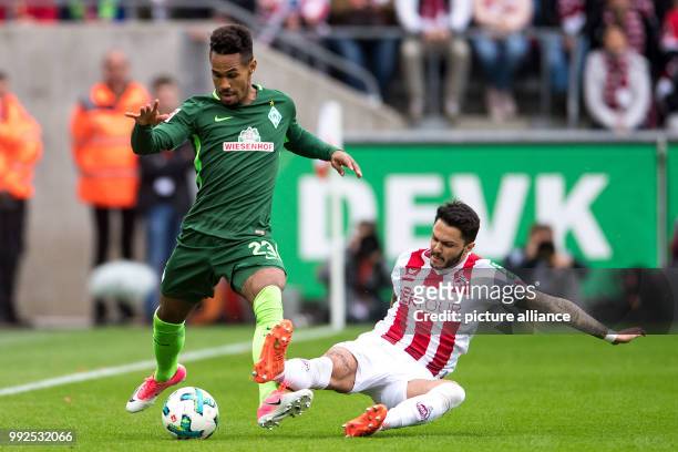 Cologne's Leonardo Bittencourt and Bremen's Theodor Gebre Selassie vie for the ball during the German Bundesliga soccer match between 1. FC Cologne...