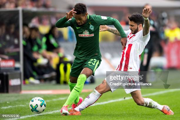 Cologne's Leonardo Bittencourt vies for the ball with Bremen's Theodor Gebre Selassie during the German Bundesliga soccer match between 1. FC Cologne...