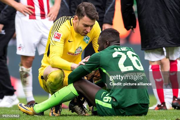 Bremen's goalkeeper Jiri Pavlenka and Lamine Sanéthe react after the German Bundesliga soccer match between 1. FC Cologne and Werder Bremen at the...