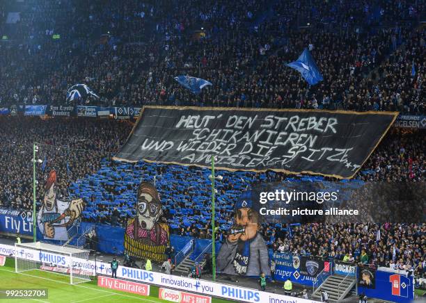 Hamburg's fans hold up a banner saying 'Heut' den Streber schikanieren und wieder die Spitze anvisieren...' during the German Bundesliga soccer match...