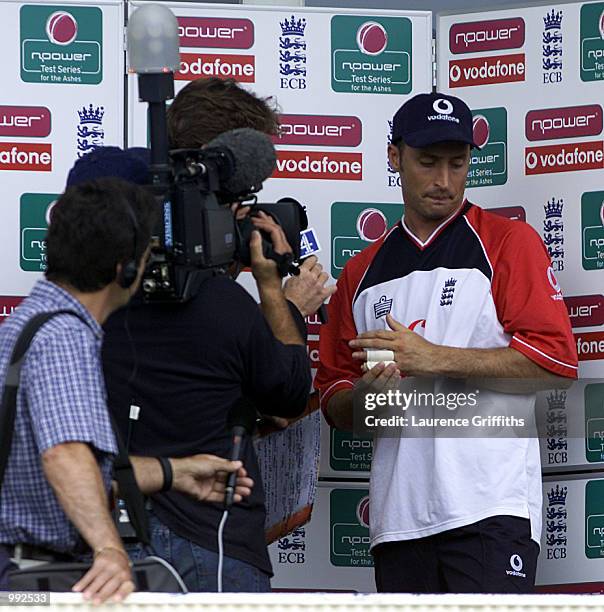 Nasser Hussain of England looks dejected with his broken finger after losing the 1st test with Mark Waugh during the 4th day of the npower Ashes...