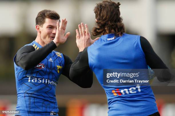 Jaeger O'Meara high fives team mate Ben Stratton during a Hawthorn Hawks AFL Training Session at Waverley Park on July 6, 2018 in Melbourne,...