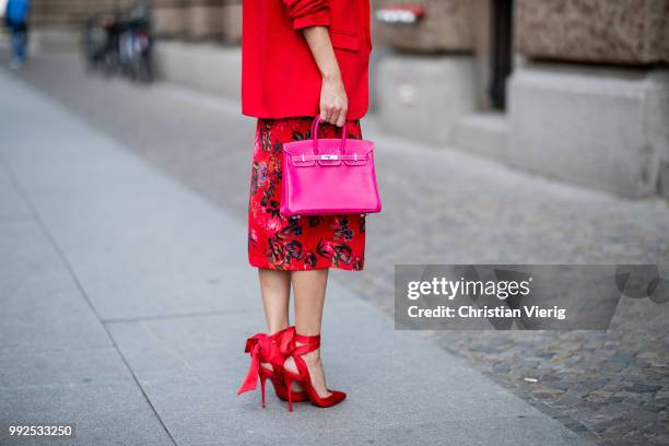 Alexandra Lapp wearing an Asian pencil skirt with a flower print from Zara, a long red Blazer with cropped sleeves from Zara, a green silk top from...